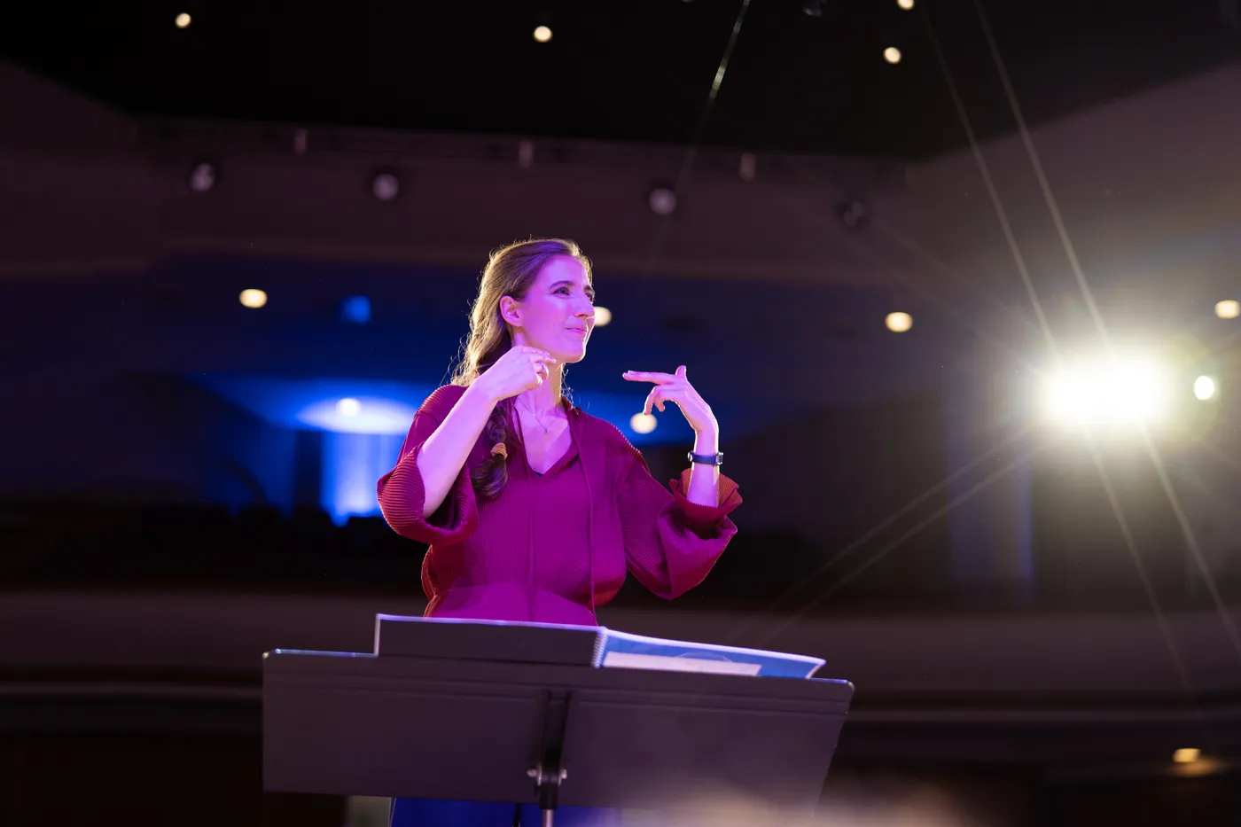 Maria on stage at a music stand